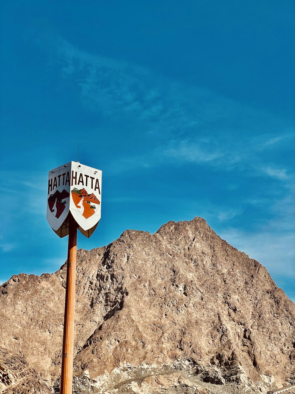 a street sign with a mountain in the background