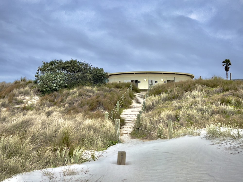 a house on a hill with stairs leading up to it