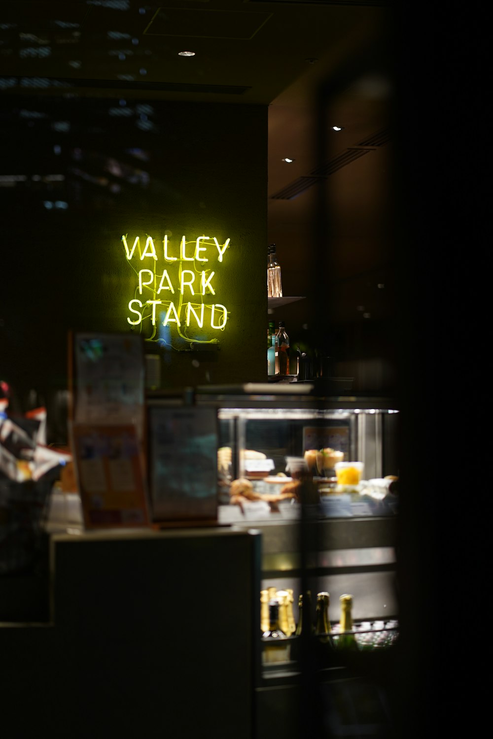 a neon sign that reads valley park stand
