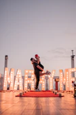 An intimate proposal scene on a rooftop terrace, featuring soft lighting and the Burj Khalifa in the background.