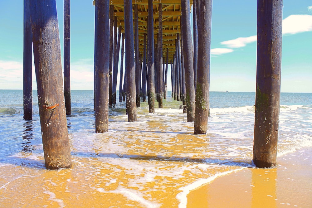 a view of the ocean under a pier