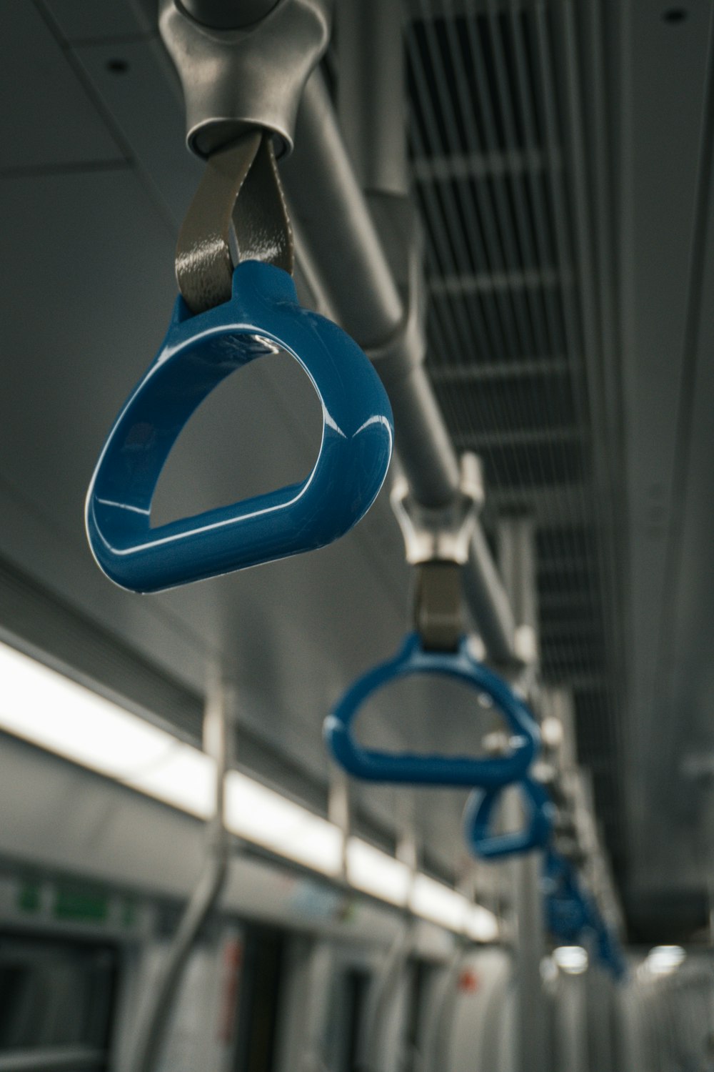 a blue pair of scissors hanging from the ceiling of a train
