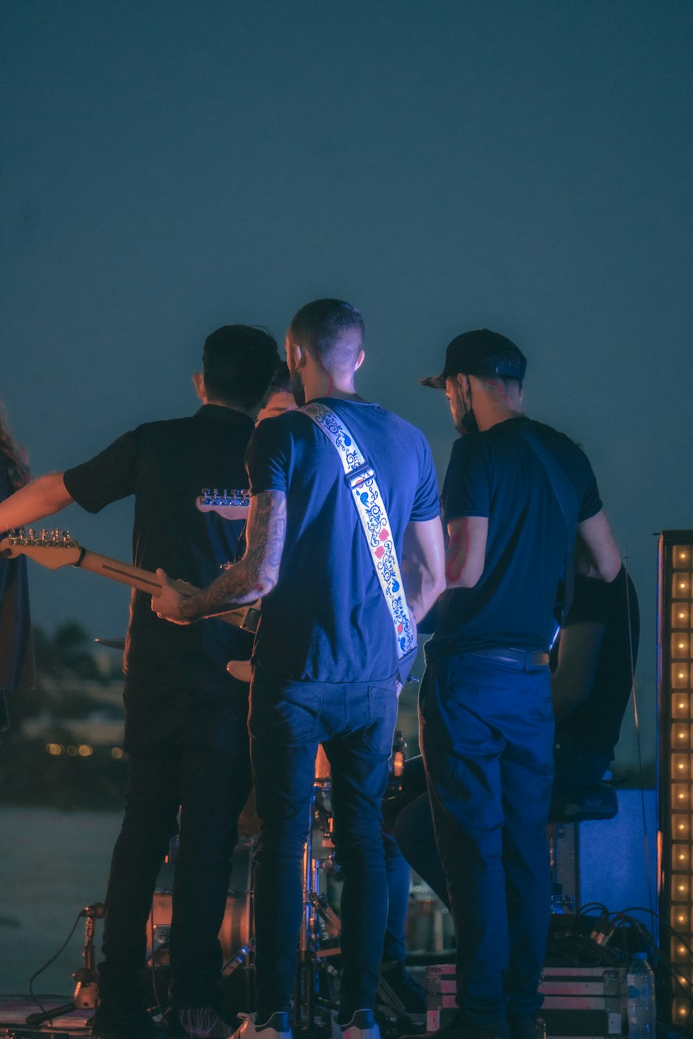 a group of men standing on top of a stage