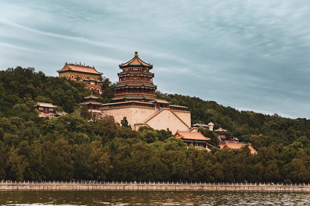 a large building sitting on top of a lush green hillside