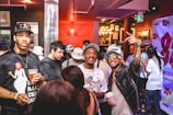 Guests enjoying a lively moment inside a photobooth with colorful props.