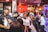 A group of diverse people enjoying various products in a bright setting.