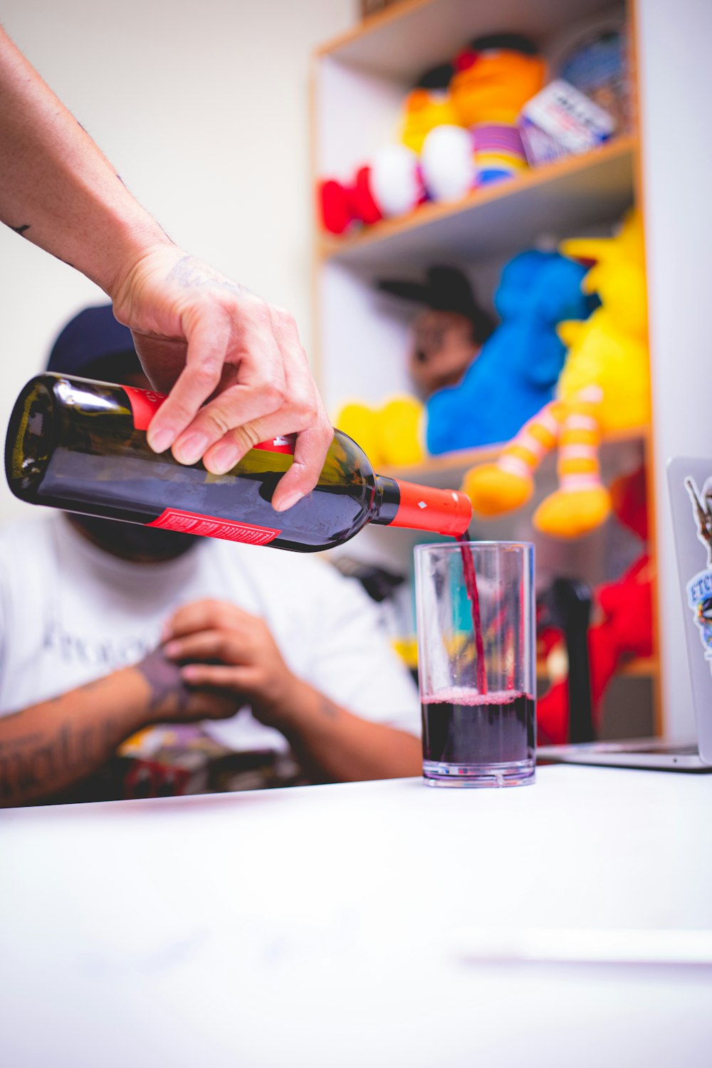 a person pouring a glass of wine into a glass