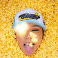 a young girl sticking her tongue out in corn