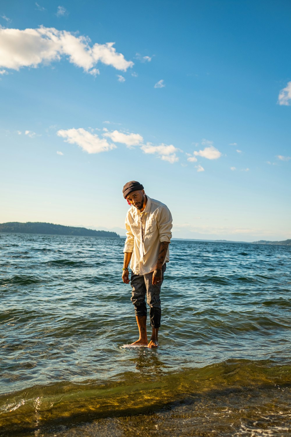 a man standing in the water looking at something