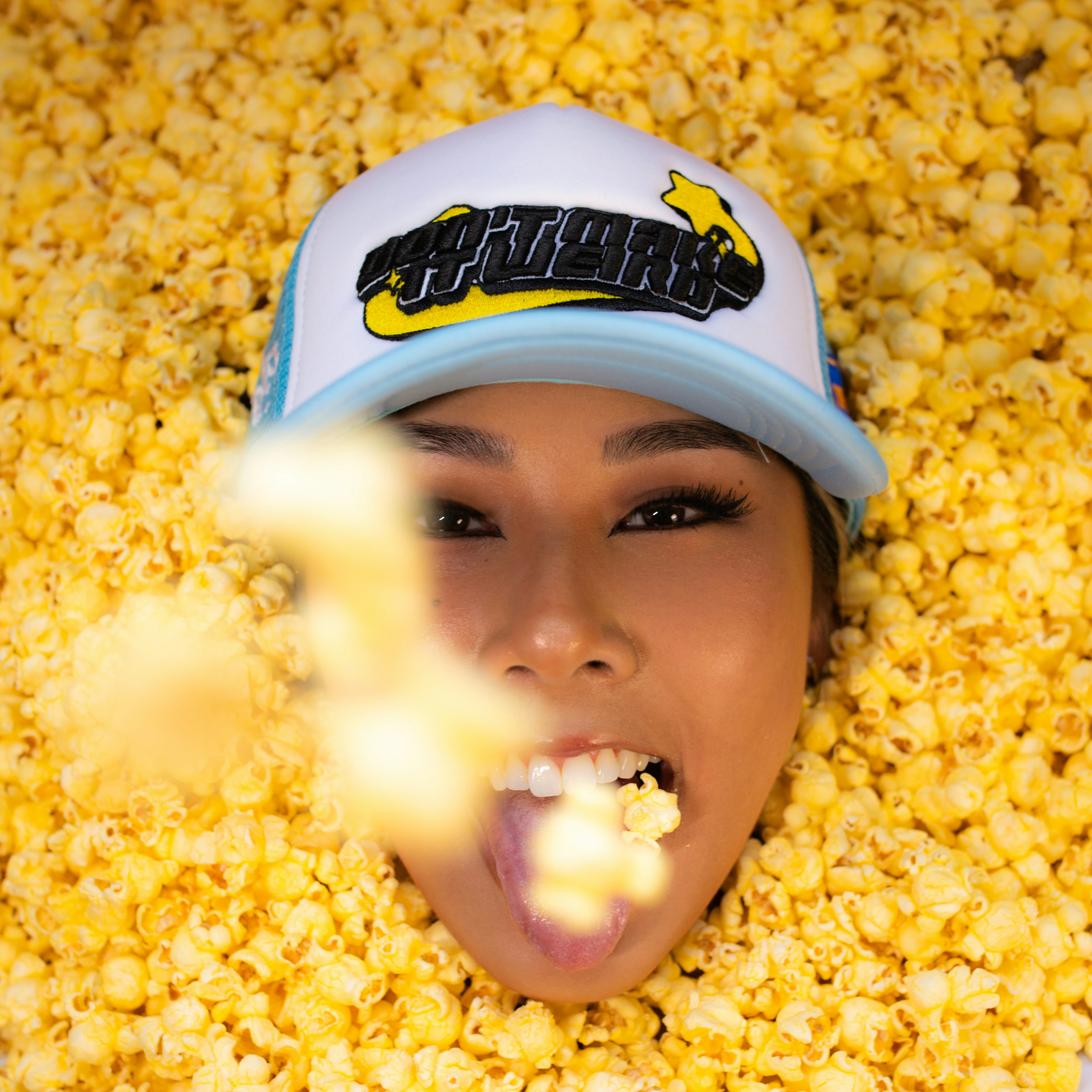 a woman with her mouth open in a pile of corn