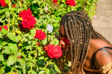 A family enjoying the scent of roses in their garden, with the spray bottle visible nearby.