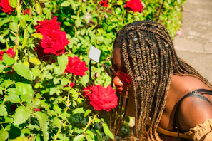 A family enjoying the scent of roses in their garden, with the spray bottle visible nearby.