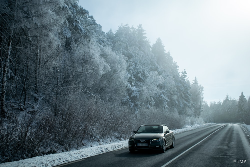 a car is driving down a snowy road