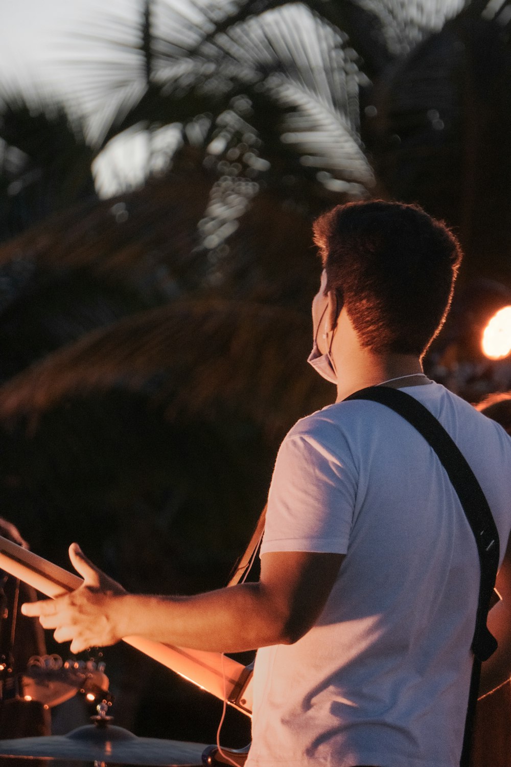 a man playing drums in front of a microphone