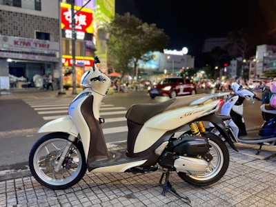 A futuristic motorbike illuminated by soft neon lights on a dark city street.
