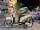 A sleek motorcycle parked on a city street at night, illuminated by neon lights.