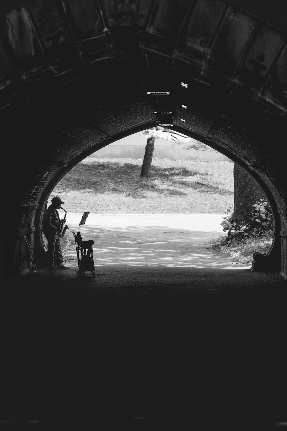 a black and white photo of a man reading a book