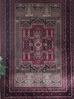 Partial view of a deep black oriental rug with subtle 3D texture and elegant patterns.