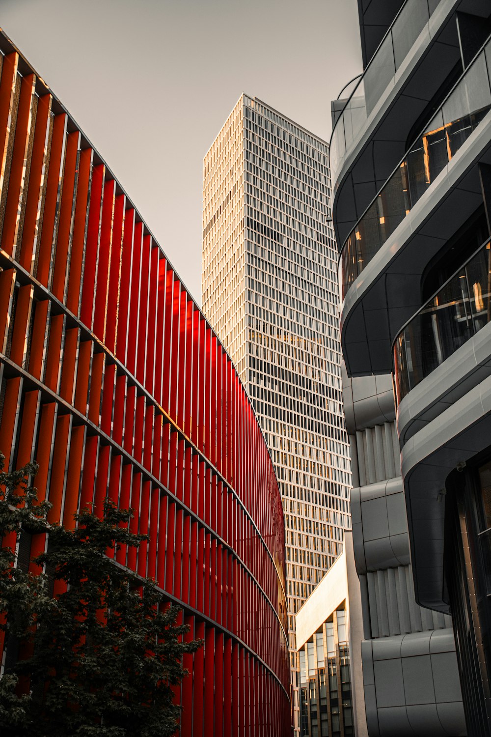 a tall red building next to a very tall red building