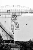 Photo of a large industrial fuel storage tank with the paprog logo on a safety sign.