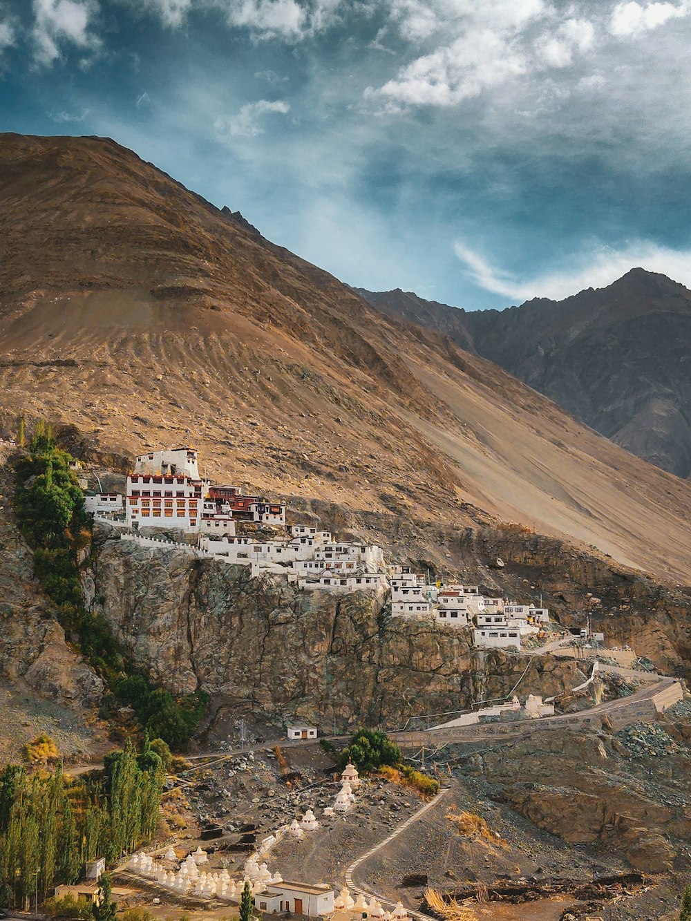 a large white building sitting on the side of a mountain