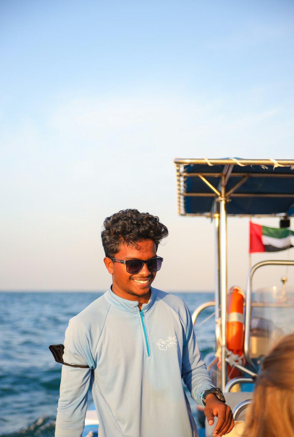 a man standing on a boat in the ocean