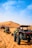 a group of four buggies driving through the desert