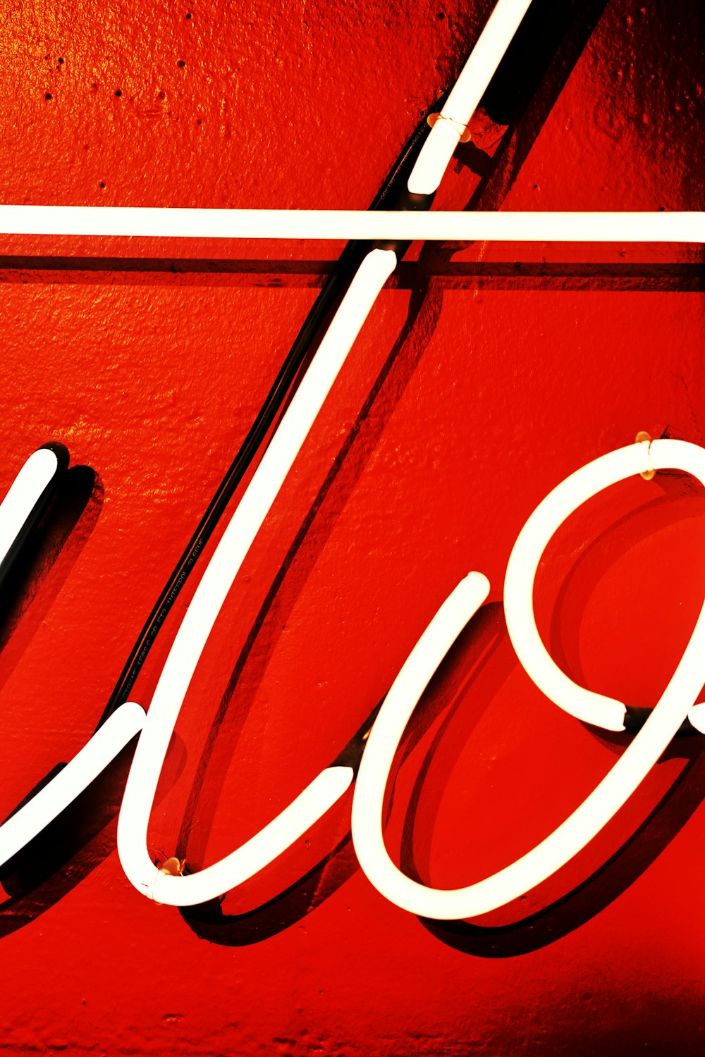a close up of a neon sign on a wall
