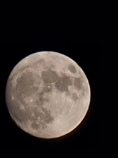 A detailed close-up of the moon's craters and surface texture.