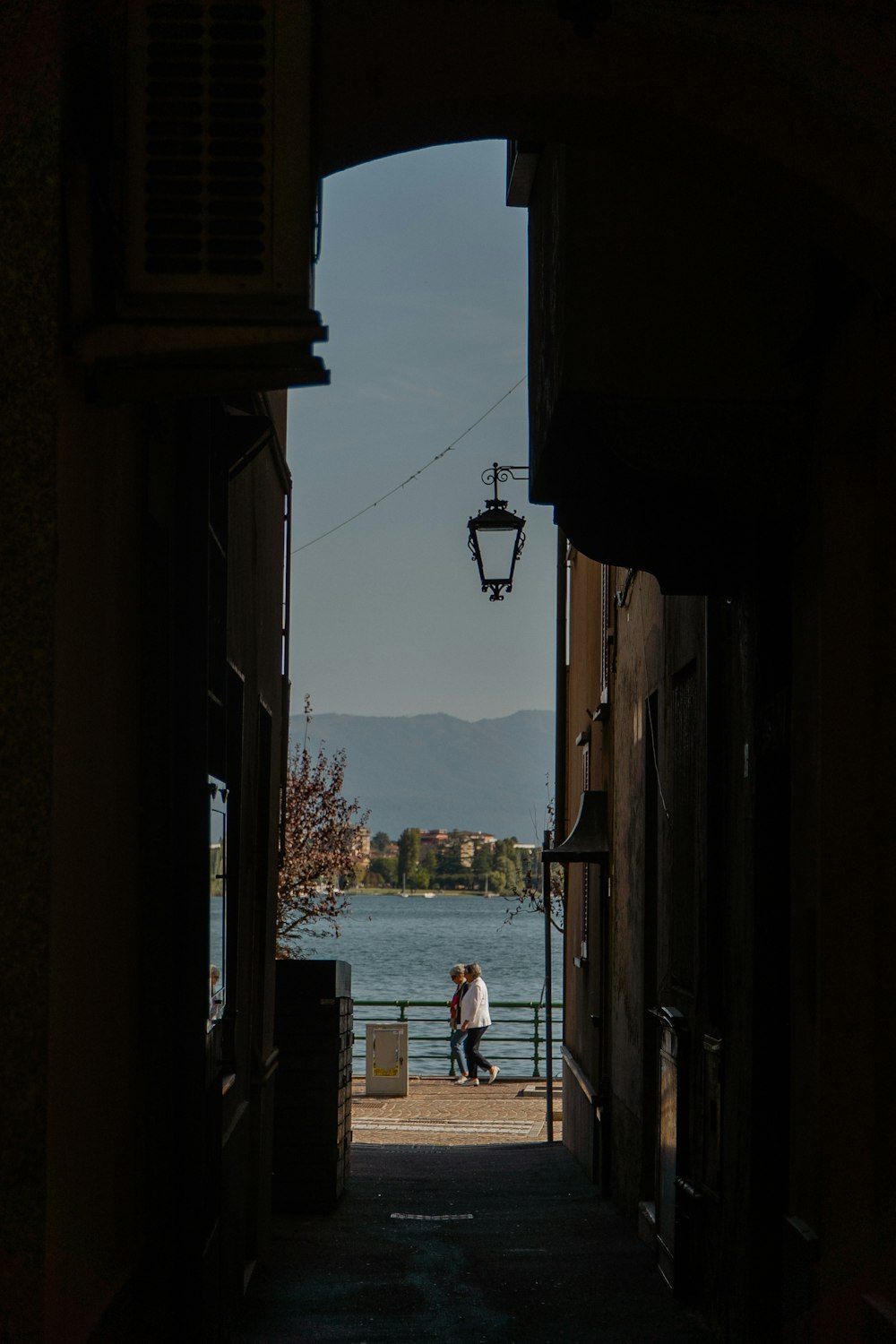 a couple of people that are walking down a street