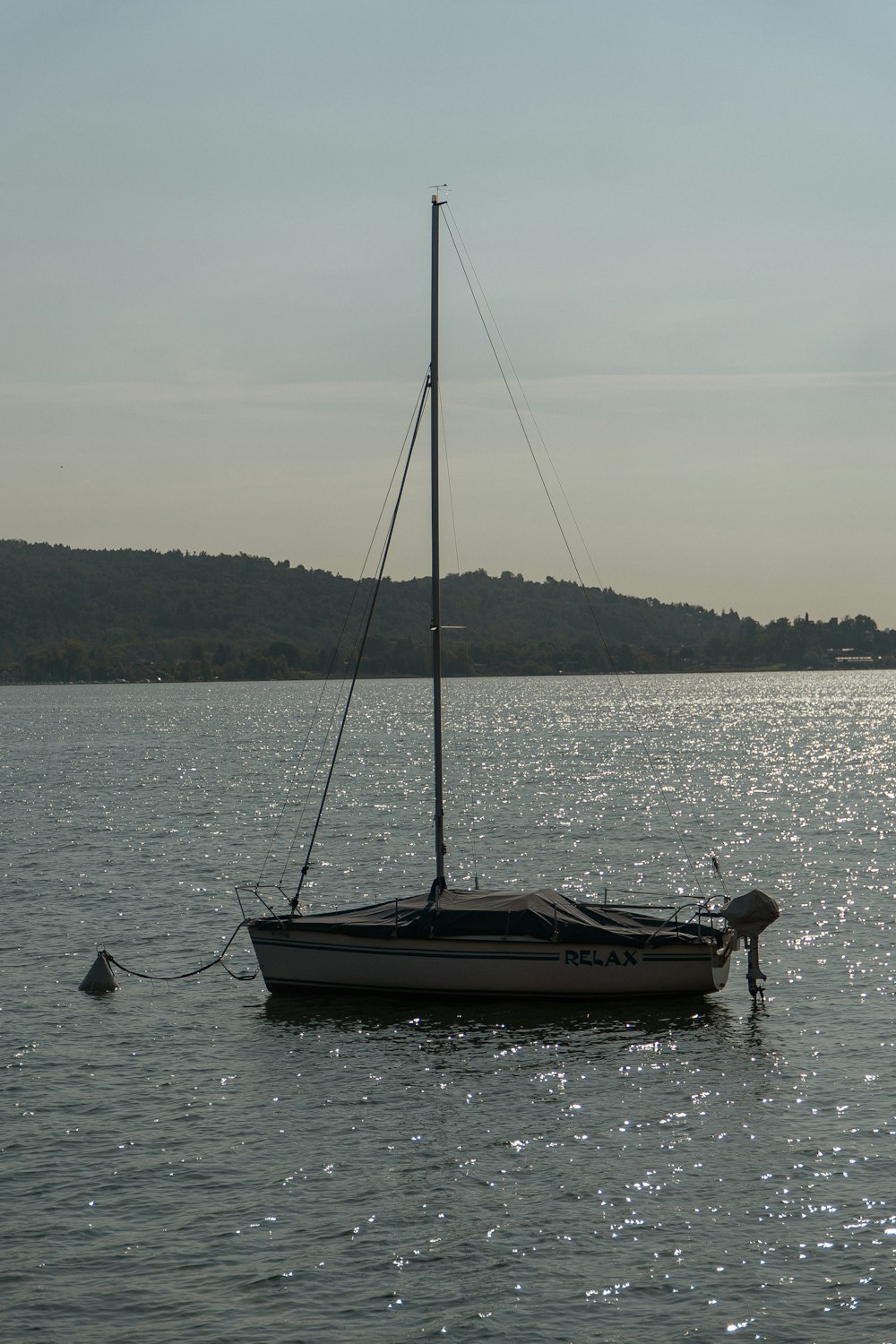 a small sailboat floating on top of a body of water