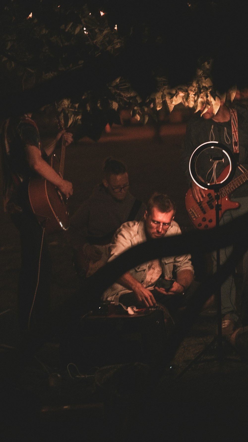 a group of people playing instruments in the dark