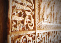 Close-up photo of restored cultural artifact with detailed patterns highlighted.