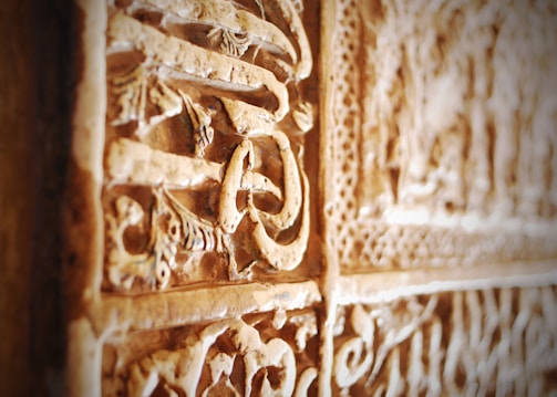 Close-up of intricate ancient carvings on stone surfaces in Kaimana.