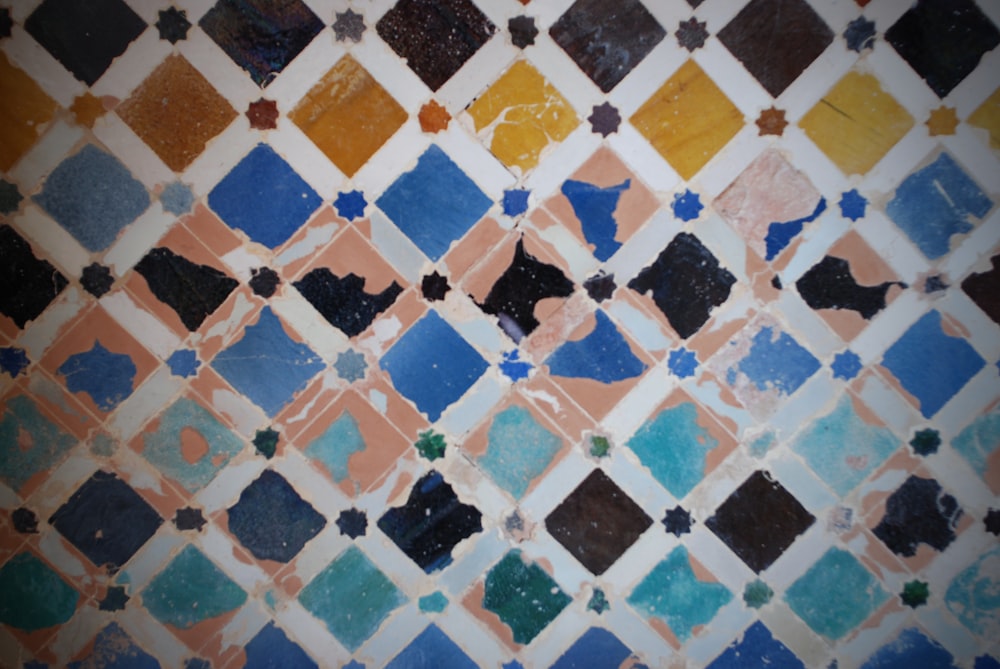 a tiled wall with different colored tiles on it