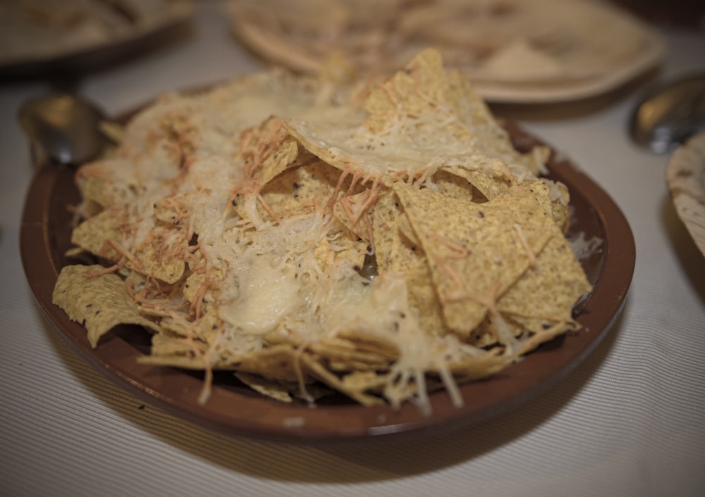 a plate full of nachos on a table