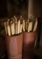 A basket of golden garlic breadsticks served with dipping sauce.
