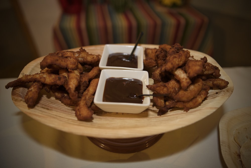 a plate of food with dipping sauce on it