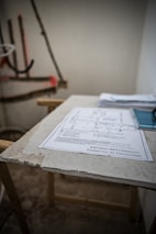 Certified safety documents and project plans laid out on a desk.