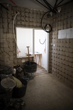 a room with a brick wall and a window