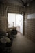 a room with a brick wall and a window