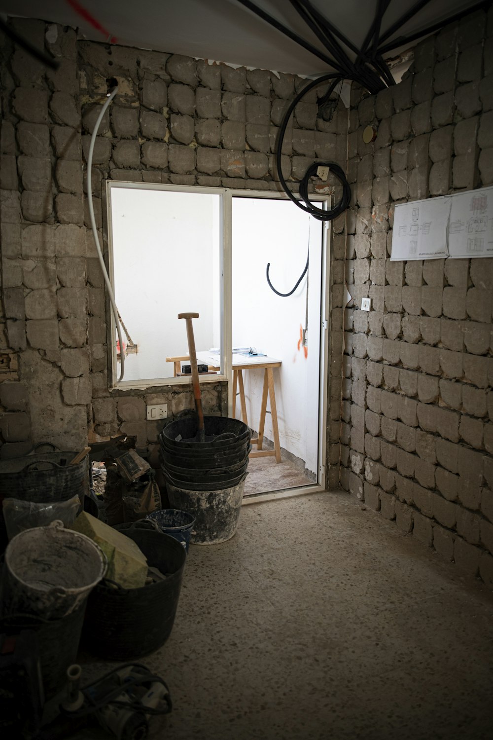 a room with a brick wall and a window