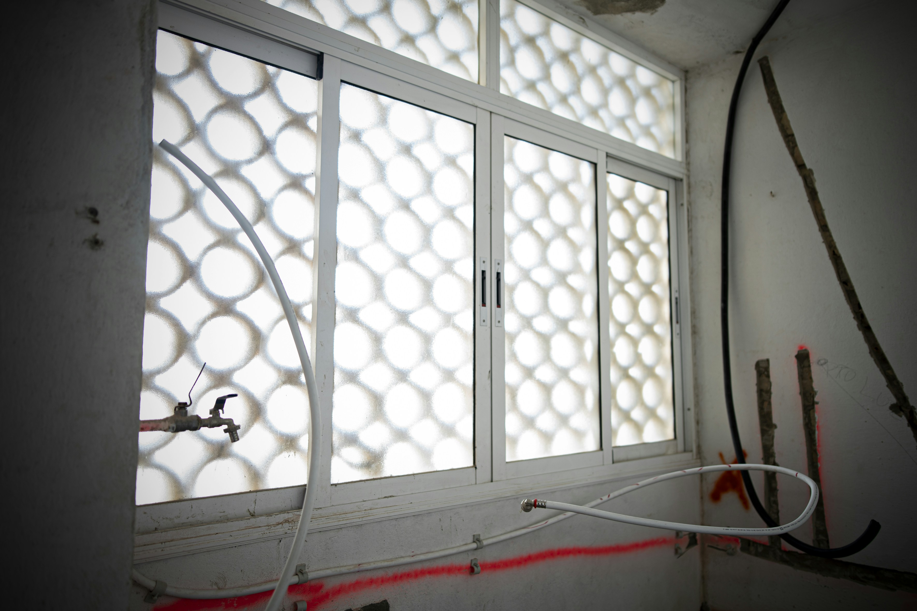 a room with a window that has some wires attached to it