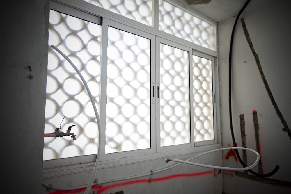 a room with a window that has some wires attached to it