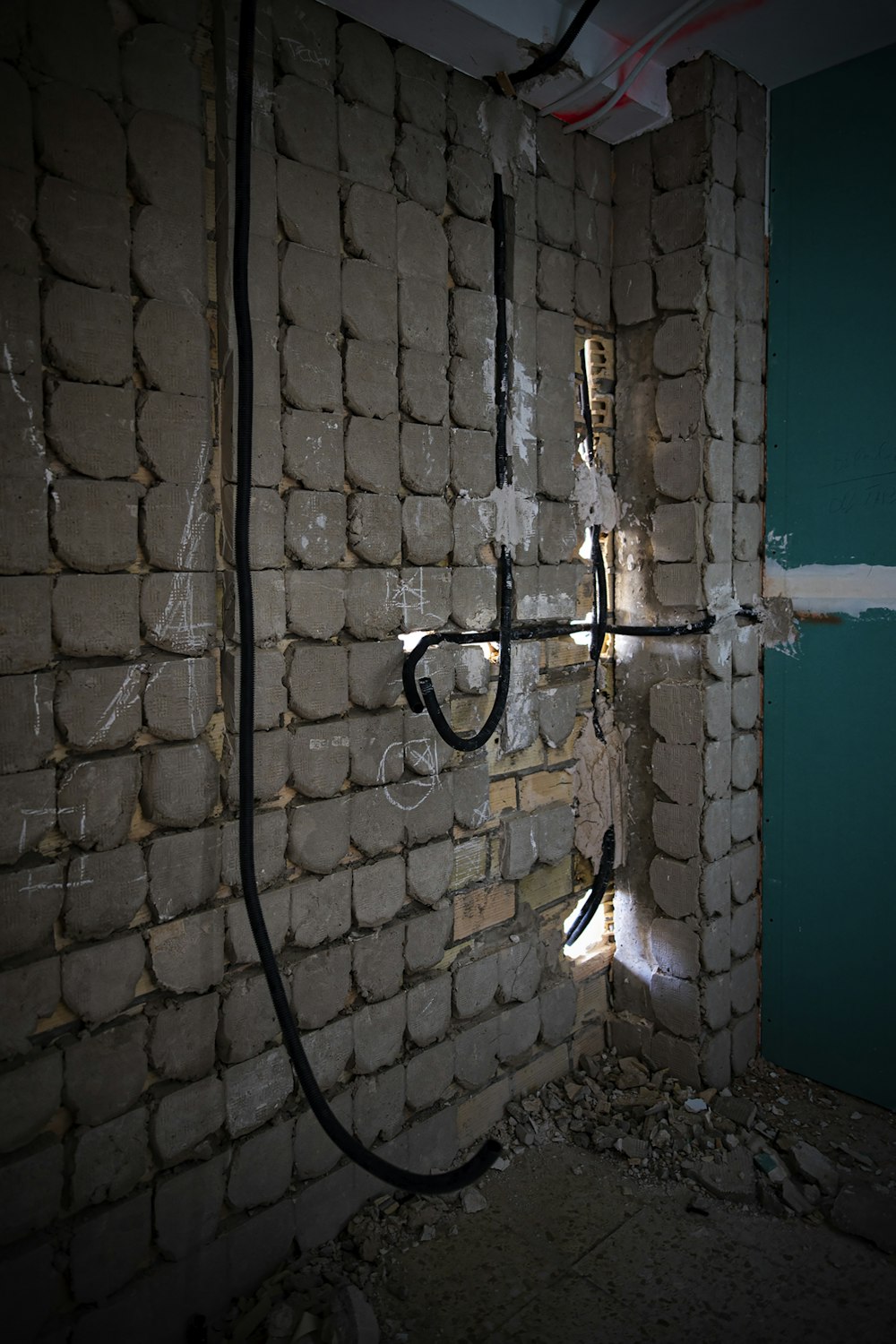 a brick wall with wires attached to it