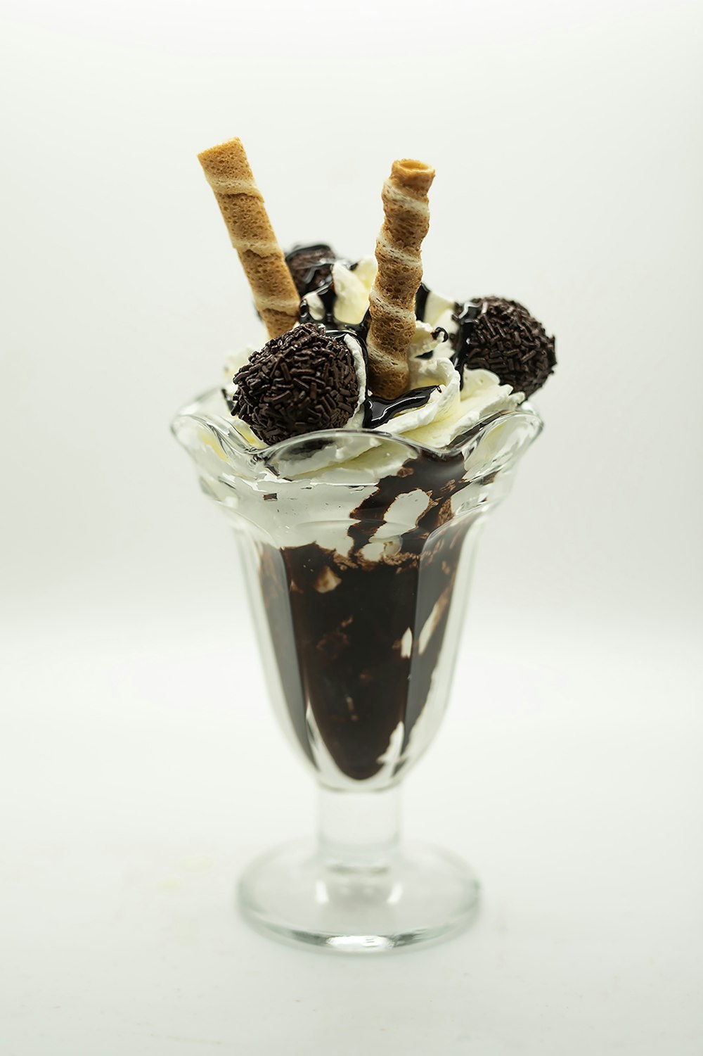 an ice cream sundae topped with chocolate and whipped cream