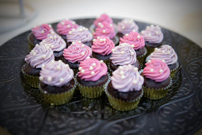 Assorted cupcakes topped with delicate chocolate drizzle and pastel frosting
