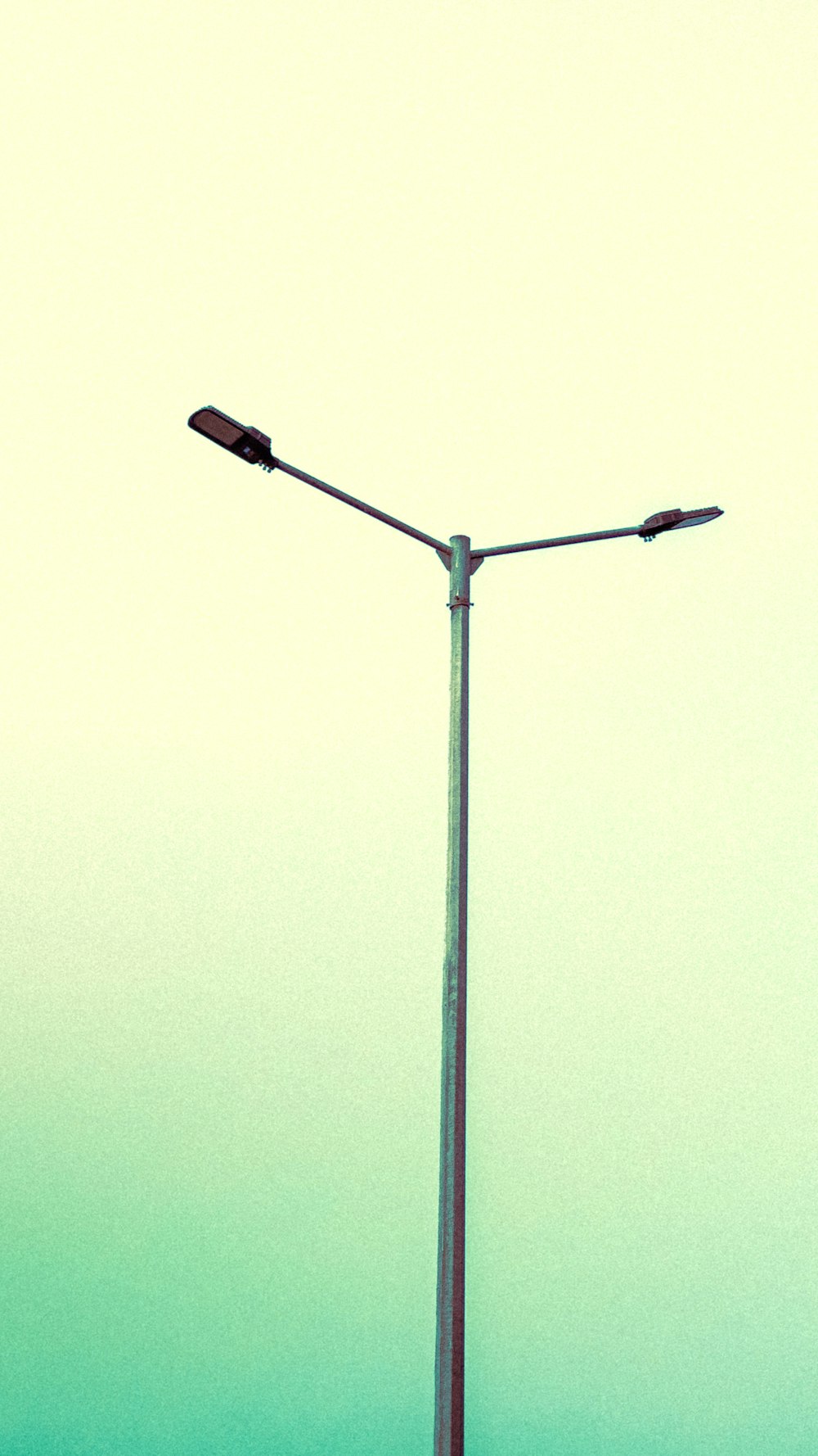 a street light on a pole with a sky background