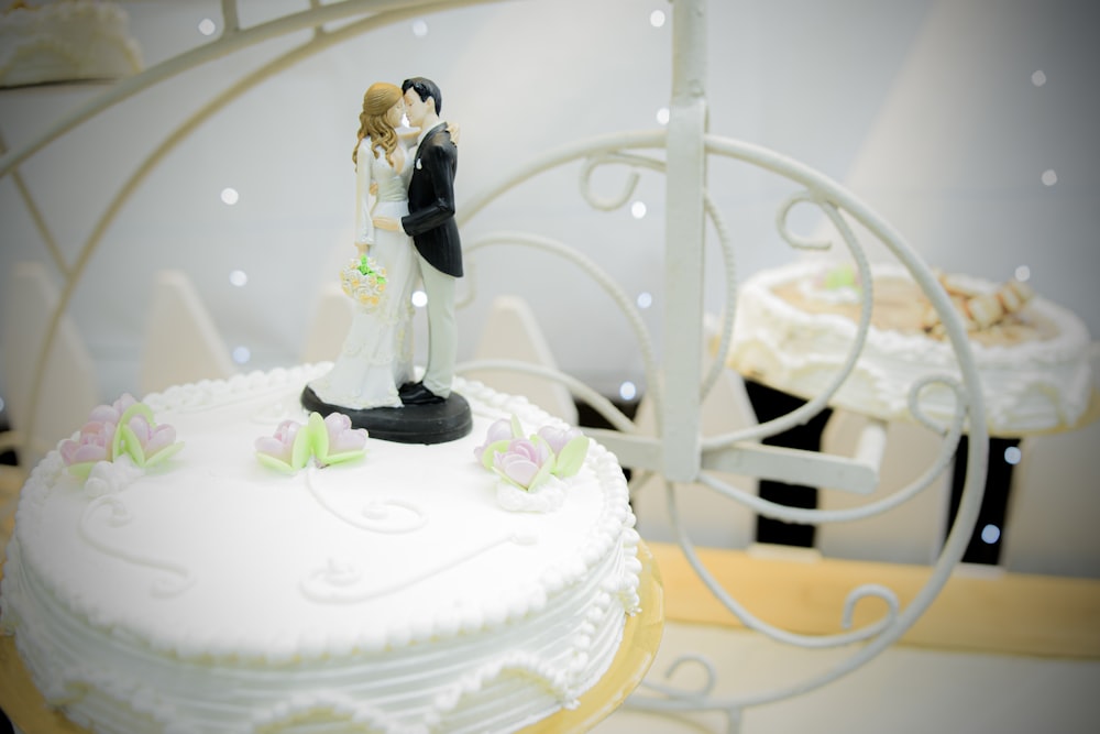 a wedding cake with a bride and groom figurine on top