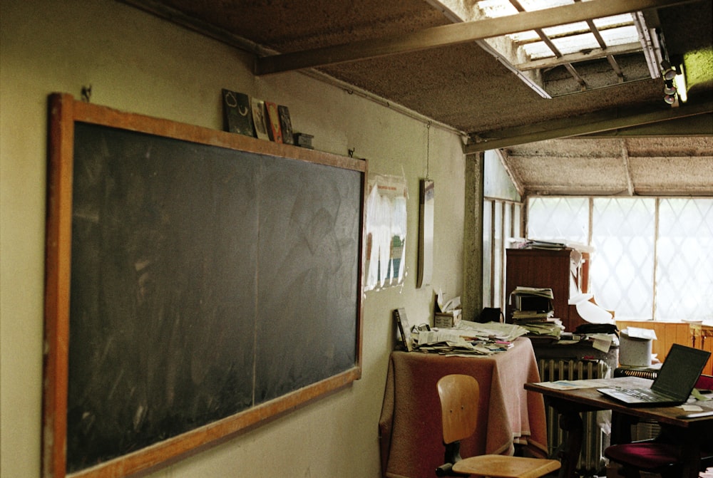 a classroom with a chalkboard and desks